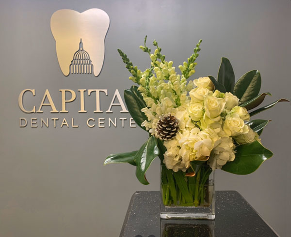 Beautiful bouquet of flowers in front of the Capital Dental Center logo in Washington D.C.